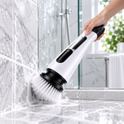 Cordless Electric Spin Scrubber cleaning a shower surface
