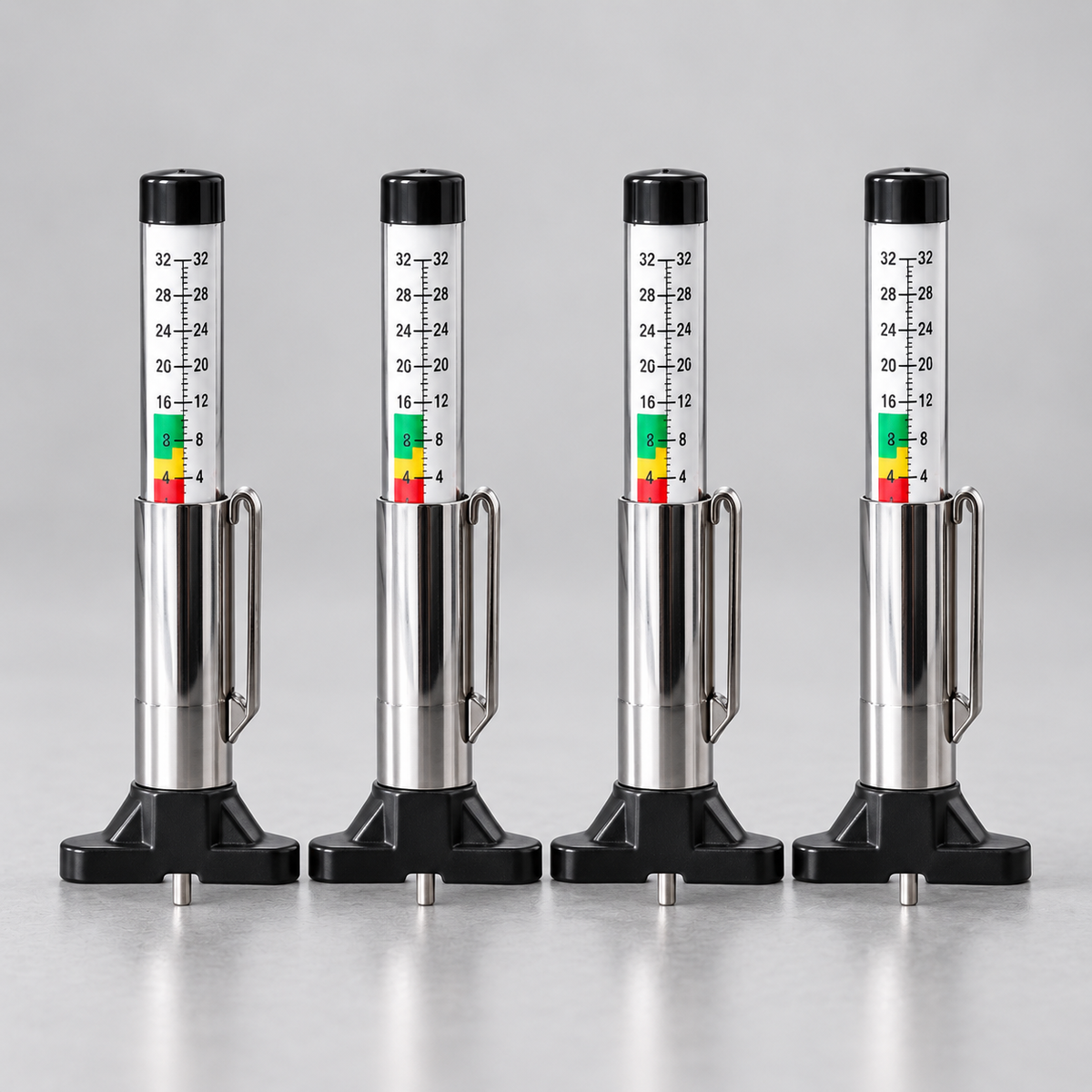 Four matching tire tread depth gauges arranged as a 4 pack
